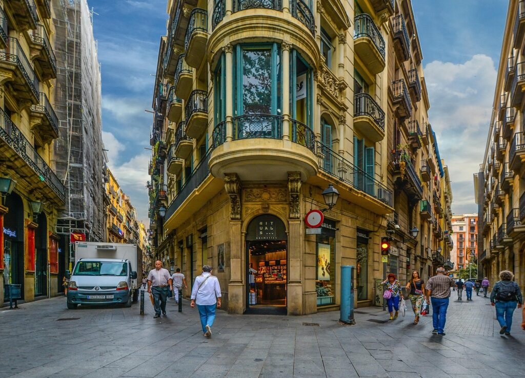 A classic Barcelona vista: a wide avenue leads to an ornate building and bifurcates into two streets, perfectly illustrating "Why Barcelona" is a city of beauty and discovery.