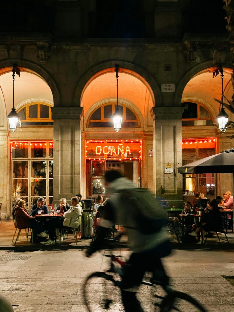 The magic of Barcelona year round: enjoying a terrace in the historic Plaza Real on a peaceful winter night, wrapped in the glow of street lamps and conversation.